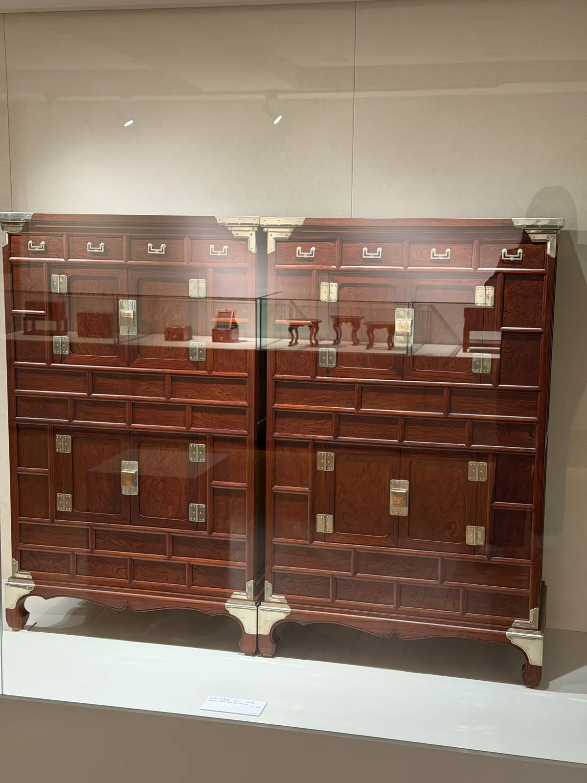 A pair of tall chests with many drawers and brass fittings