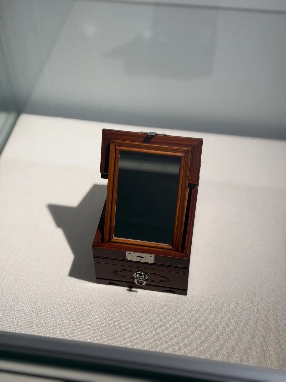 The same box open, with a mirror standing inside
