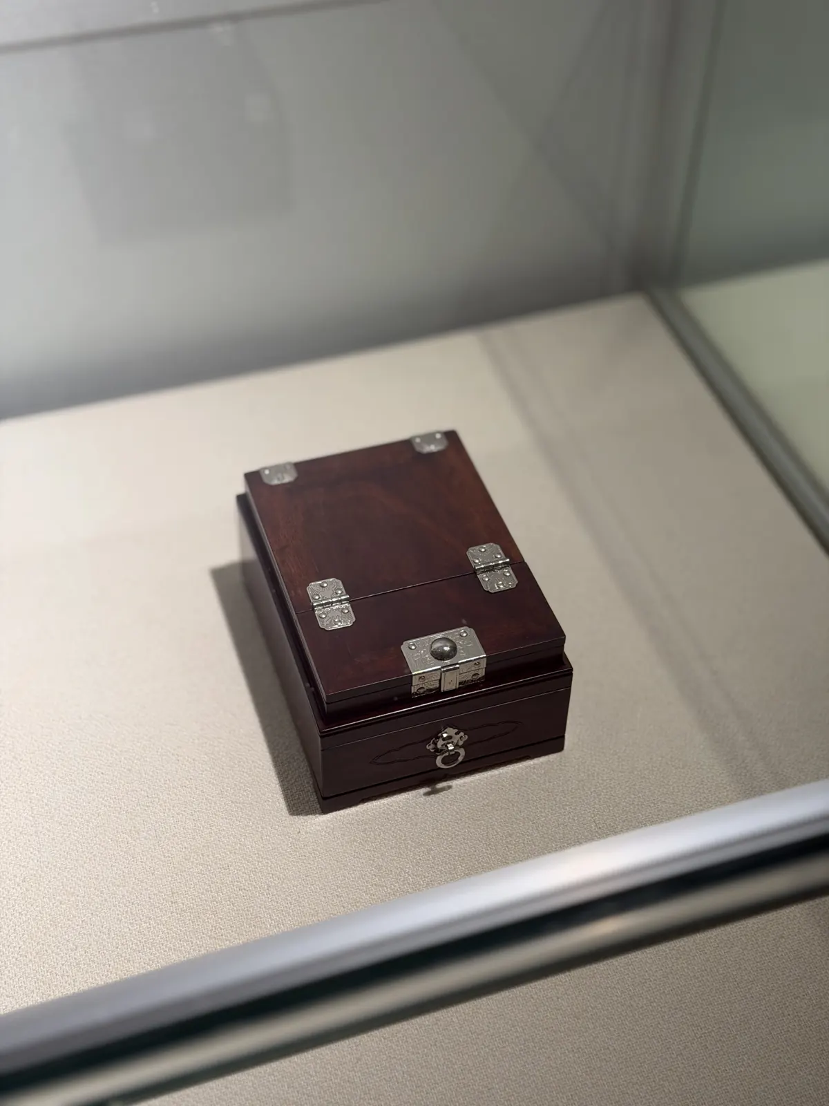 A small dark box with silver hinges